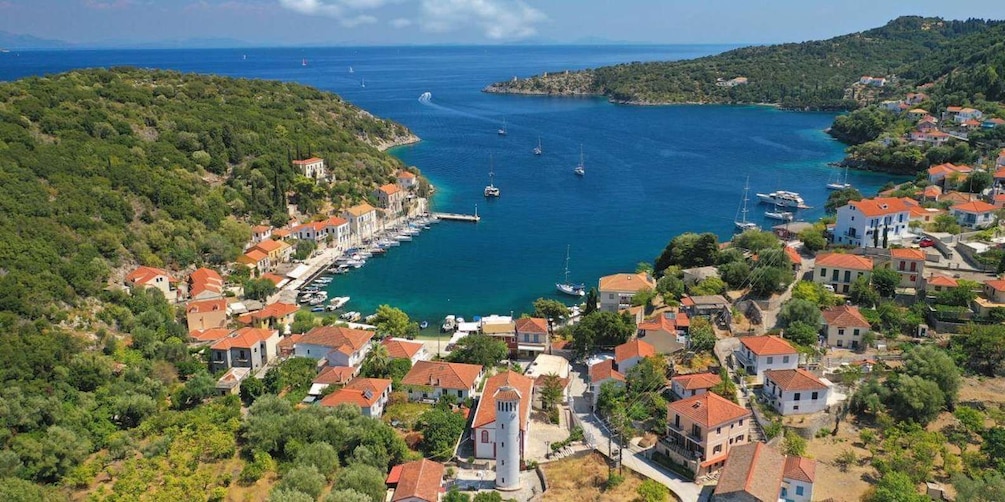 A coastal village with red-roofed houses, a marina, and boats. 3