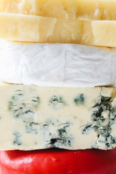 A stack of cheese slices with varying colors and textures. 1