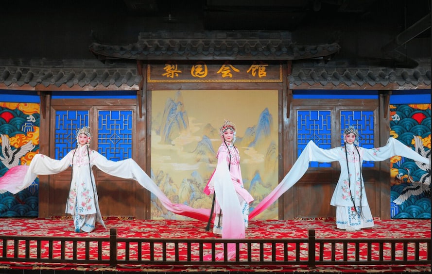 A traditional Chinese stage with performers in elaborate costumes. 2
