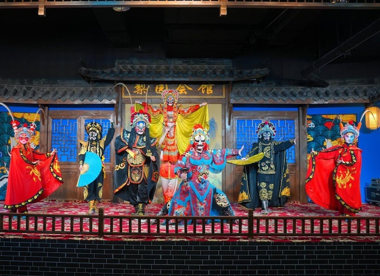 A traditional Chinese opera performance with actors in elaborate costumes and masks. 3