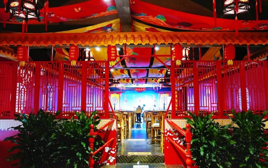 A traditional Chinese building with red decorations and a stage at the front. 4