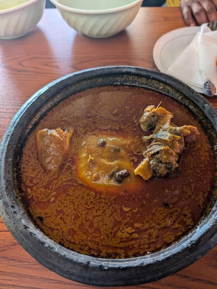 A bowl of stew with meat and vegetables. 1
