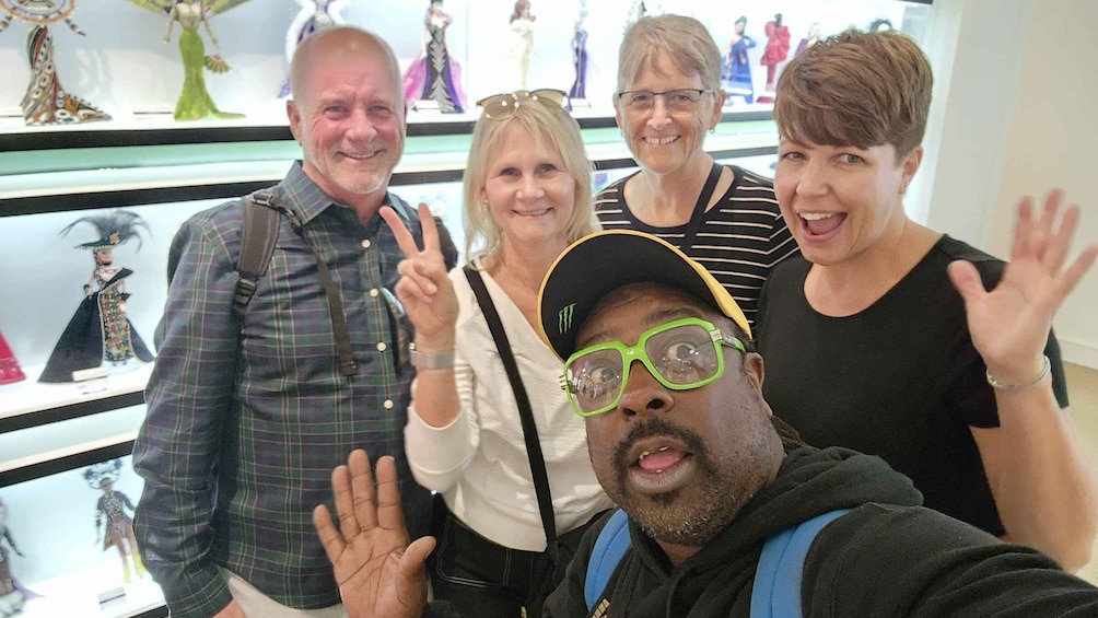 A group of people posing in front of a display with figurines. 4