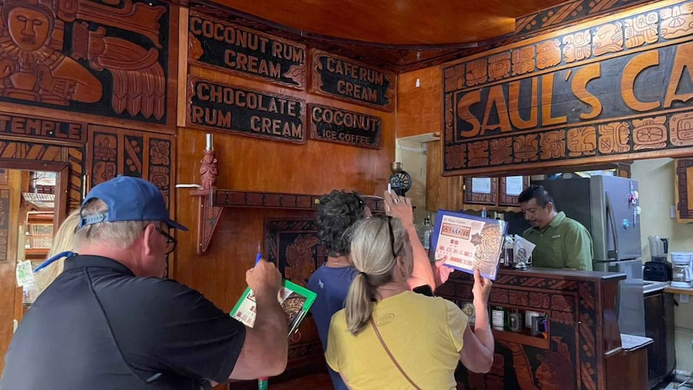 A bar with wooden decor and signs for drinks like coconut rum cream and chocolate rum cream. 4
