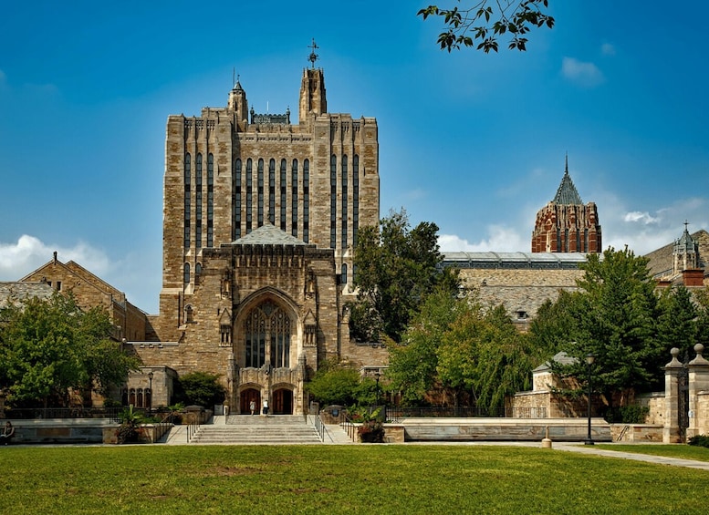 A large stone building with a prominent entrance and a smaller tower in the background. 3