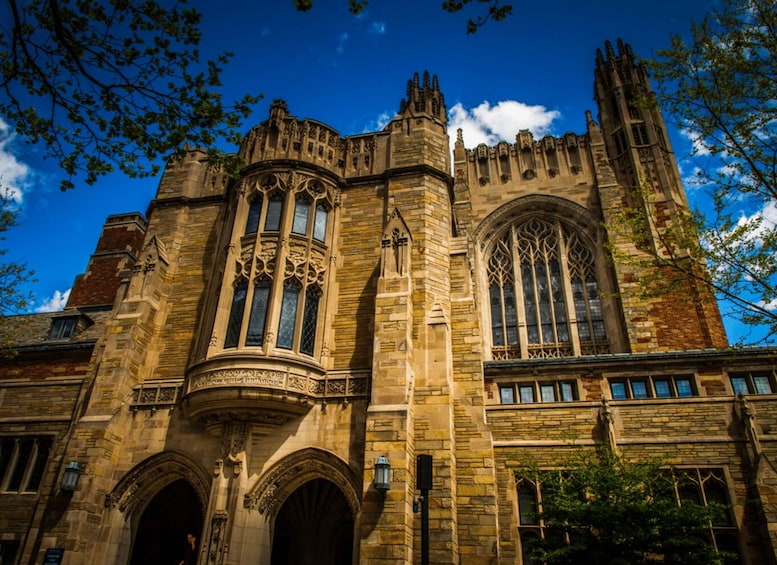 A historic stone building with arched windows and intricate stonework. 4