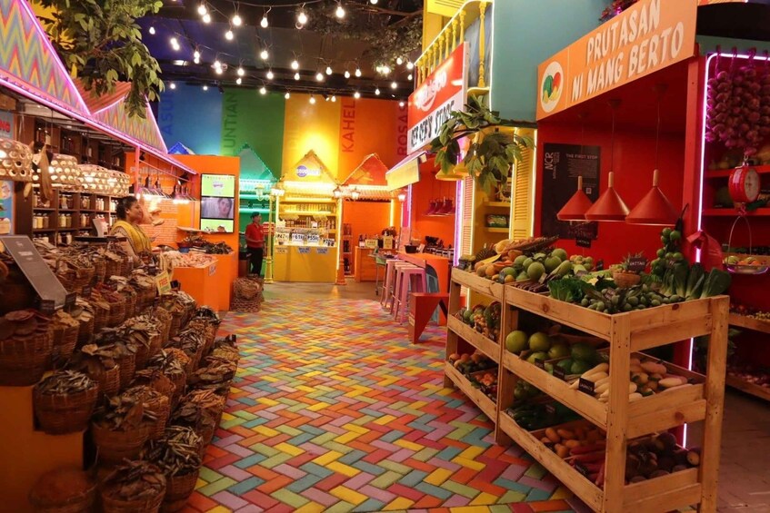 A colorful indoor market with various stalls, including a fruit display and a section with baskets of goods. 5
