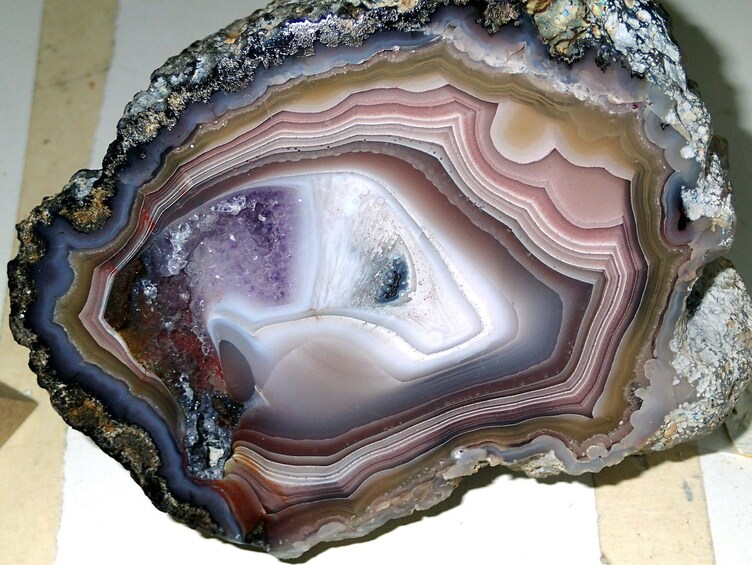 A close-up of a geode with layered colors and a central crystal formation. 2