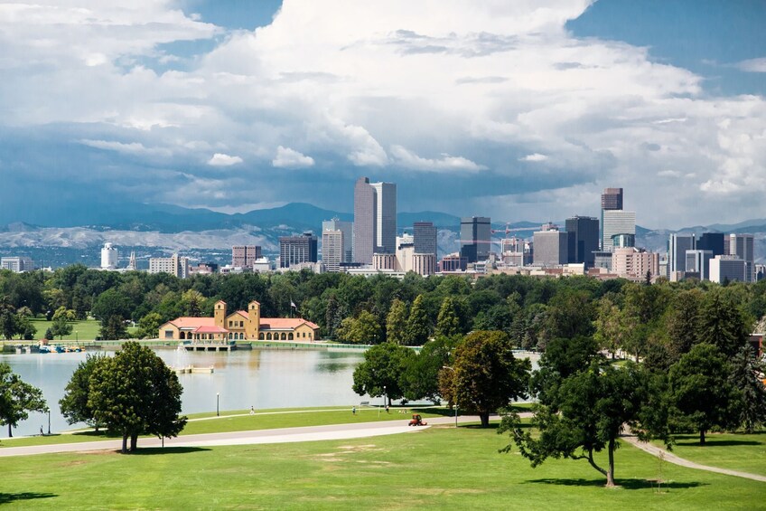 A city skyline with modern skyscrapers, a park with a lake, and a historic building. 4