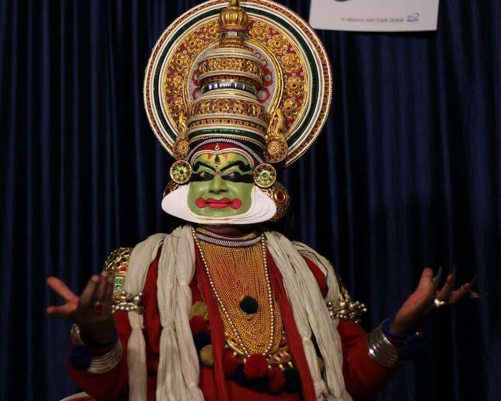 A person in traditional attire with elaborate headgear and jewelry. 1