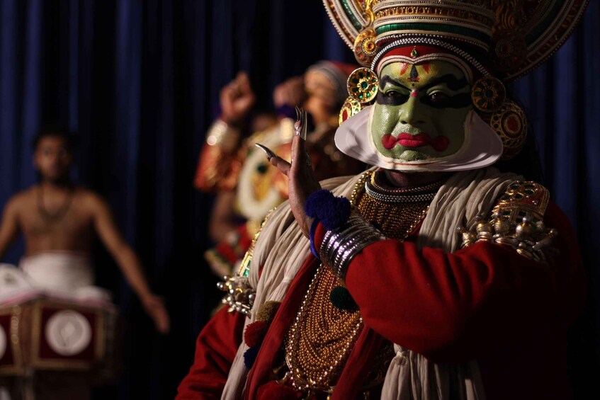 A person in traditional attire with elaborate headgear and jewelry. 3