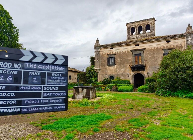A film set with a clapperboard in front of a historic building. 1