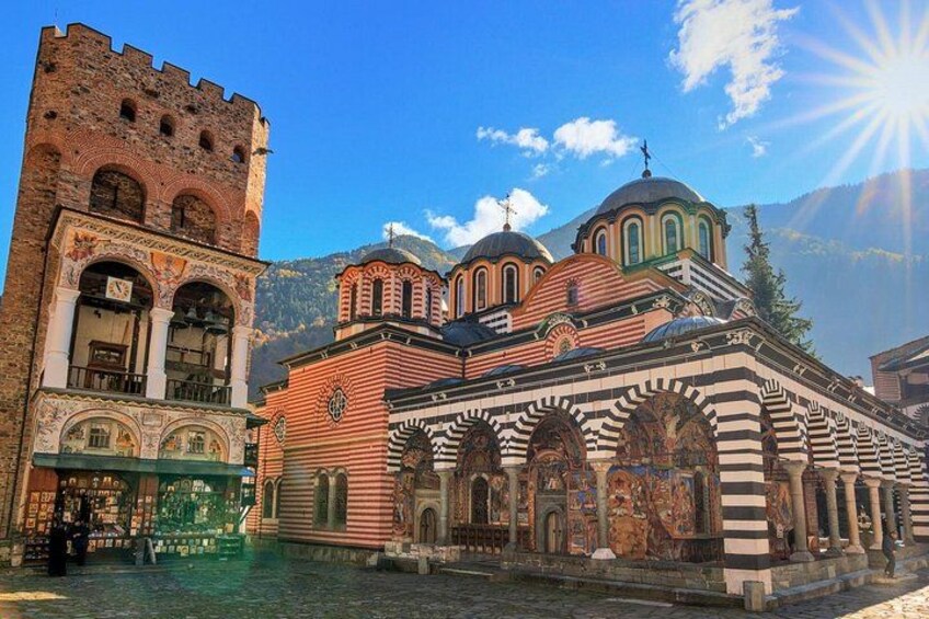 A historic building with a bell tower and domed roof, surrounded by a body of water. 5