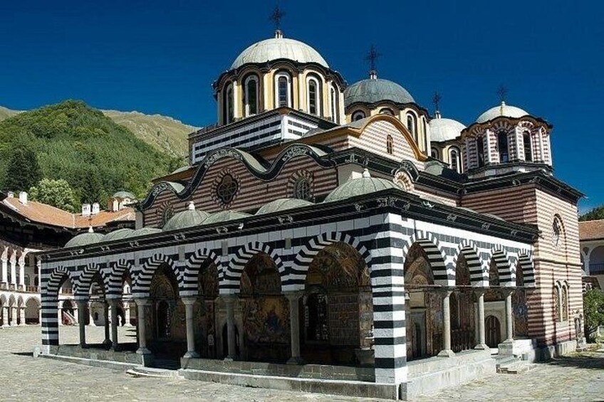 A historic church with multiple domes and arches. 1