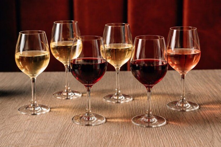 Six wine glasses on a wooden surface. 5