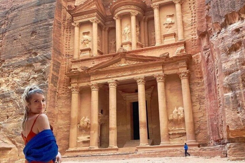 A carved rock facade with columns and a doorway, likely part of an ancient structure. 3