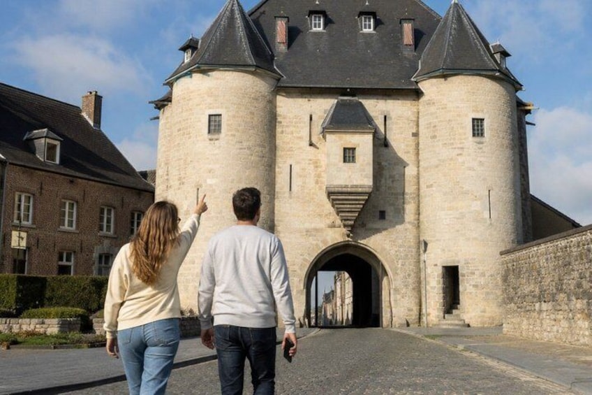 A historic stone building with a tower and arched entrance. 4