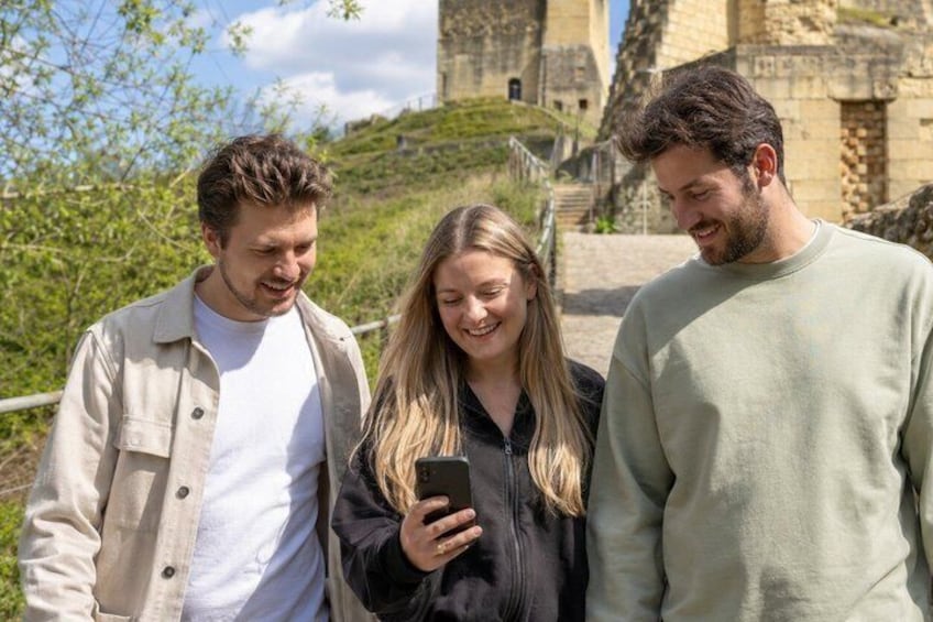 Three people standing outdoors with a historical building in the background. 3