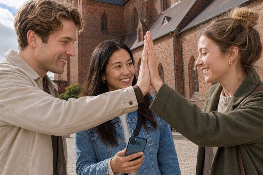A group of people in front of a brick building with arched windows. 2