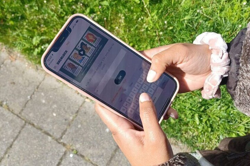 A person holding a smartphone with a social media app open. 2