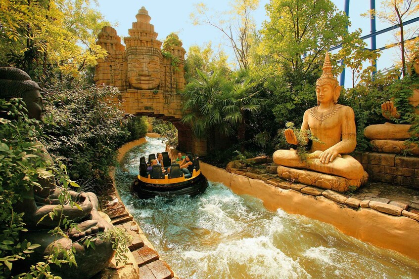 A water ride with a large Buddha statue and a temple-like structure in the background. 4