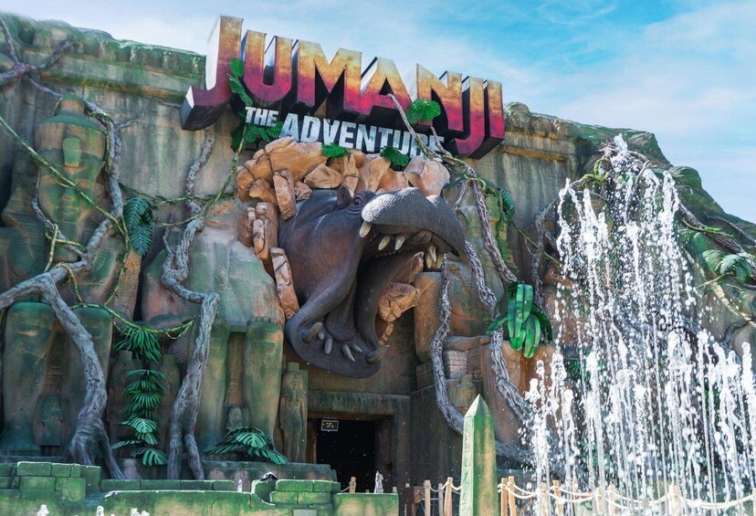 A jungle-themed entrance with a large sign for 'Jumanji: The Adventure,' a waterfall feature, and stone carvings. 3