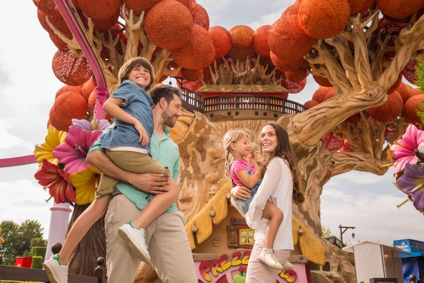A family at a theme park with a treehouse attraction. 1