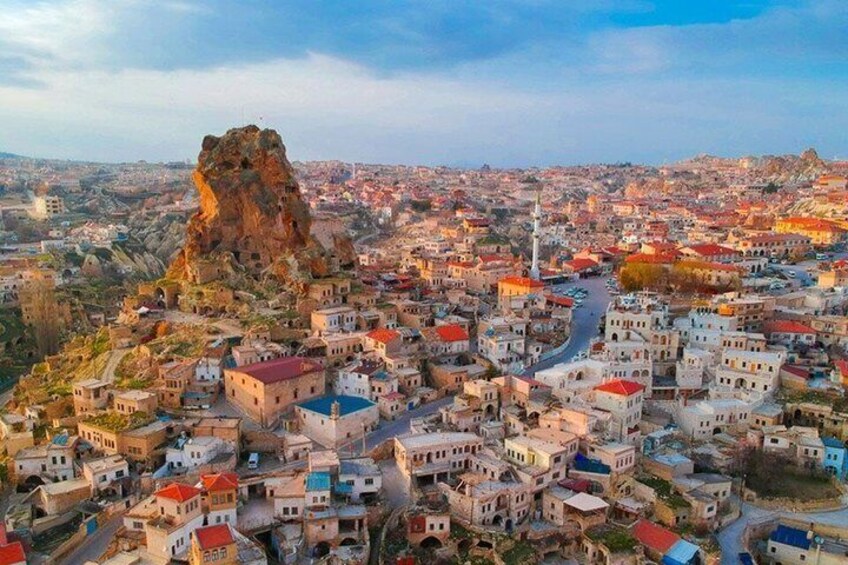A town with a prominent rock formation and a mosque. 5
