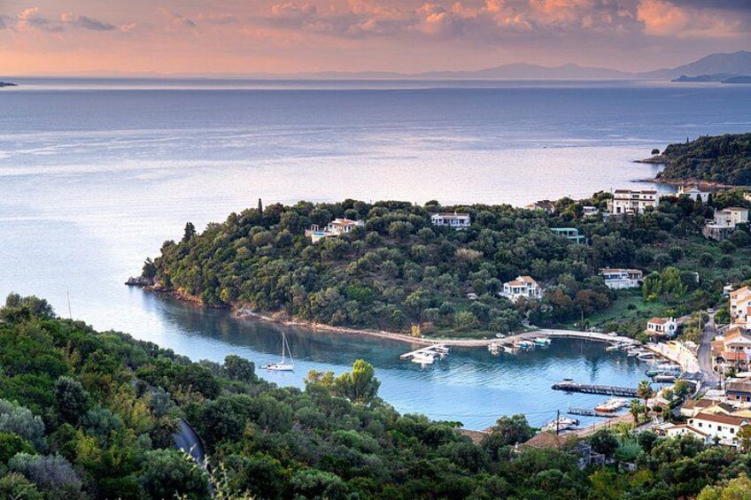 A coastal landscape with a small island, boats, and houses. 4