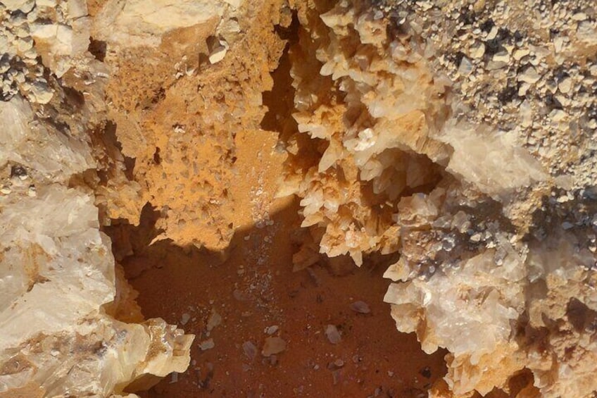 A close-up of a rock formation with a reddish-brown mineral deposit. 4