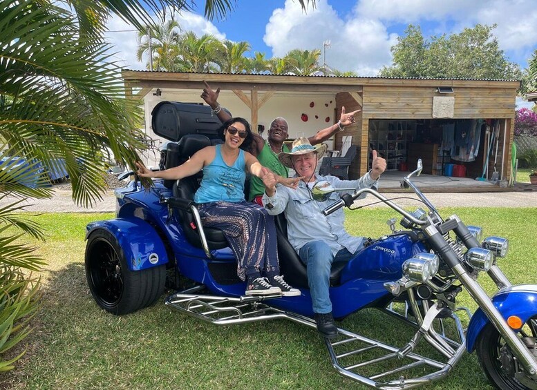 A blue motorcycle with a sidecar, three people on it, and a building in the background. 5
