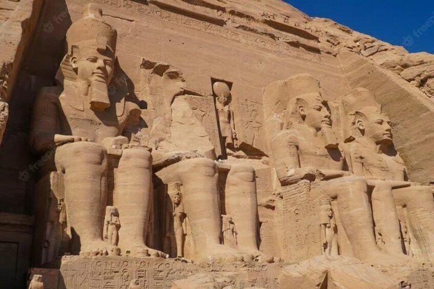 A large sandstone structure with carved figures and hieroglyphs. 3