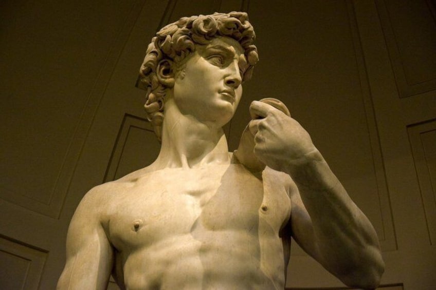 A classical marble statue with a muscular build, wearing a laurel wreath, and a hand raised to the shoulder. 3