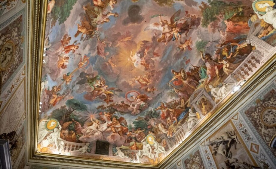 A detailed fresco mural on a ceiling with classical figures and architectural elements. 4
