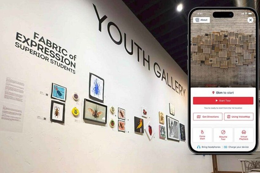 A wall with framed artwork and a smartphone displaying a map. 1