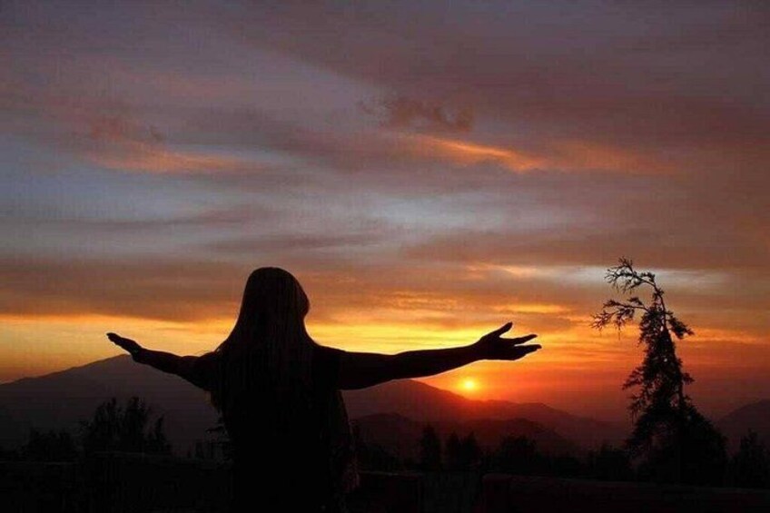A silhouette of a person with arms outstretched against a sunset sky. 4