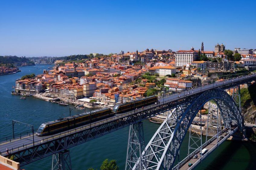 A bridge over water with a cityscape in the background. 1