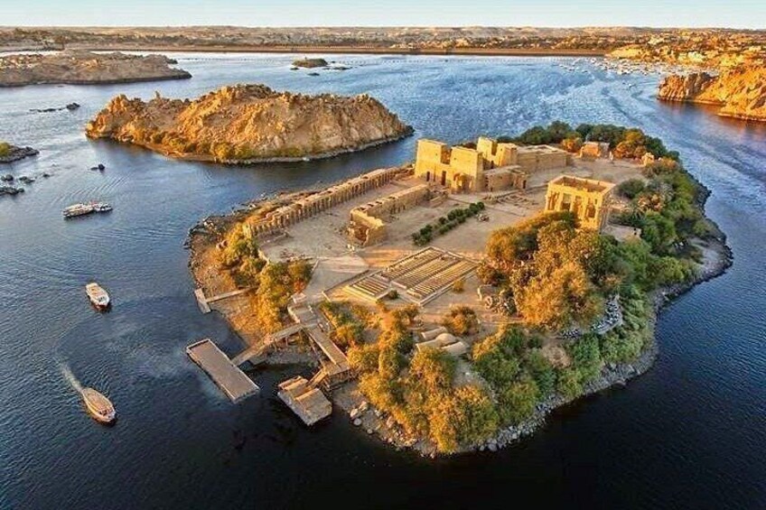 An aerial view of an island with ancient ruins and a dock. 3