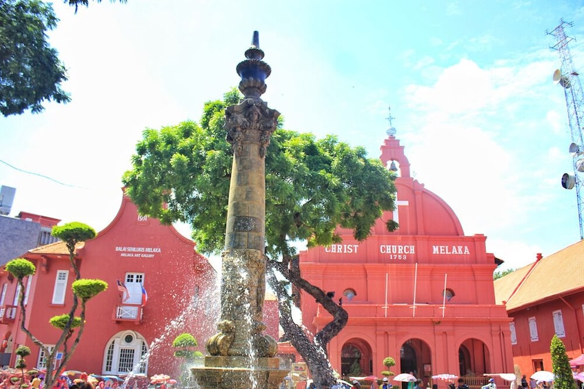 A fountain with water jets, a red church with 'CHRIST CHURCH MELAKA 1753' on its facade, and a building labeled 'BALAI SEMINAR KELANA ART GALLERY.' 4