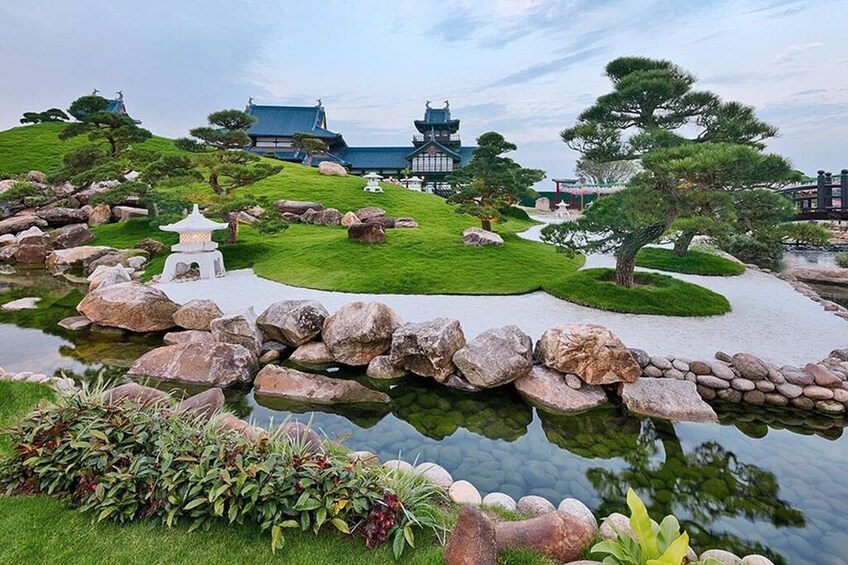A traditional Japanese garden with a pond, rocks, and a pagoda. 5