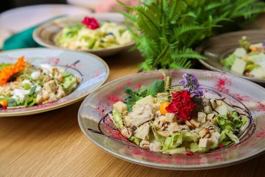 Three plates of salad with various toppings and garnishes. 3