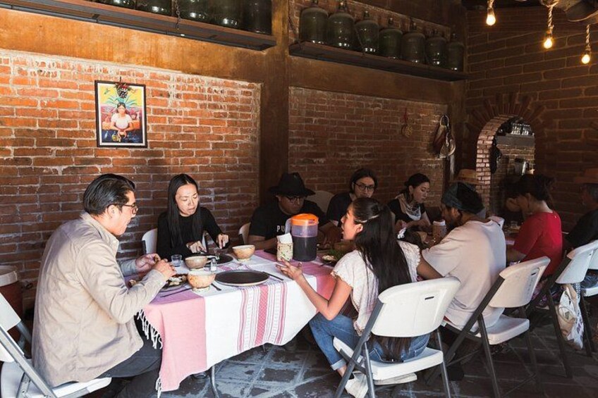 A group of people dining at a brick-walled restaurant with a rustic interior. 5