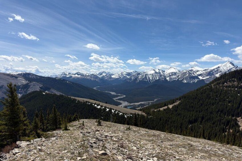 A mountain landscape with snow-capped peaks, a valley, and a river. 3