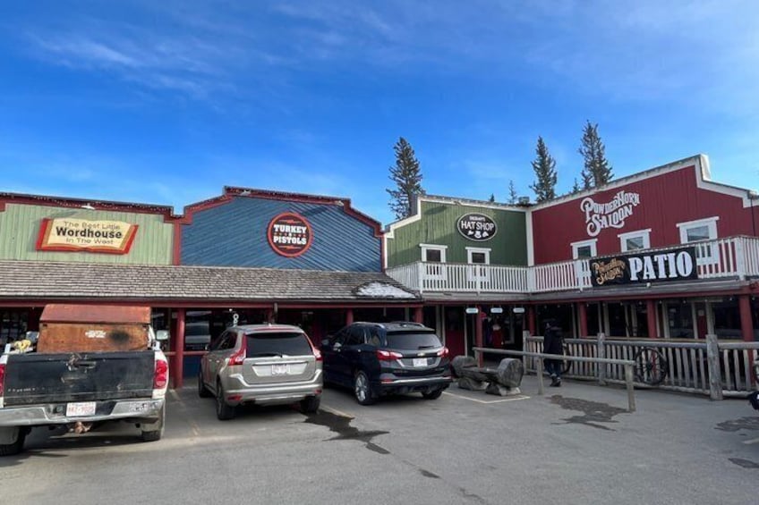 A street with buildings labeled 'The Backwoods Warehouse,' 'Turkey Pistols,' and 'Patio.' 1