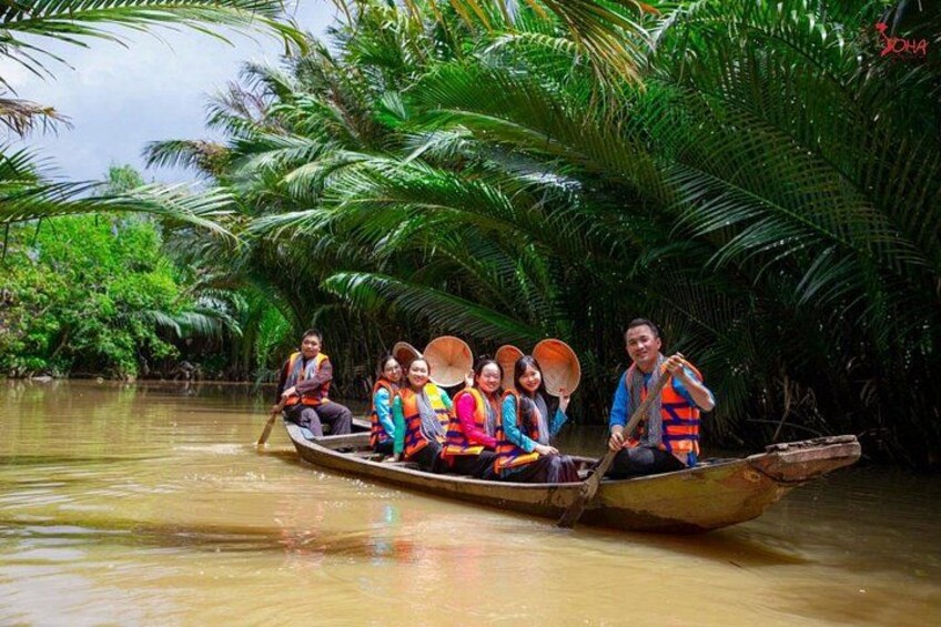 A group of people in a boat on a river surrounded by dense tropical vegetation. 2
