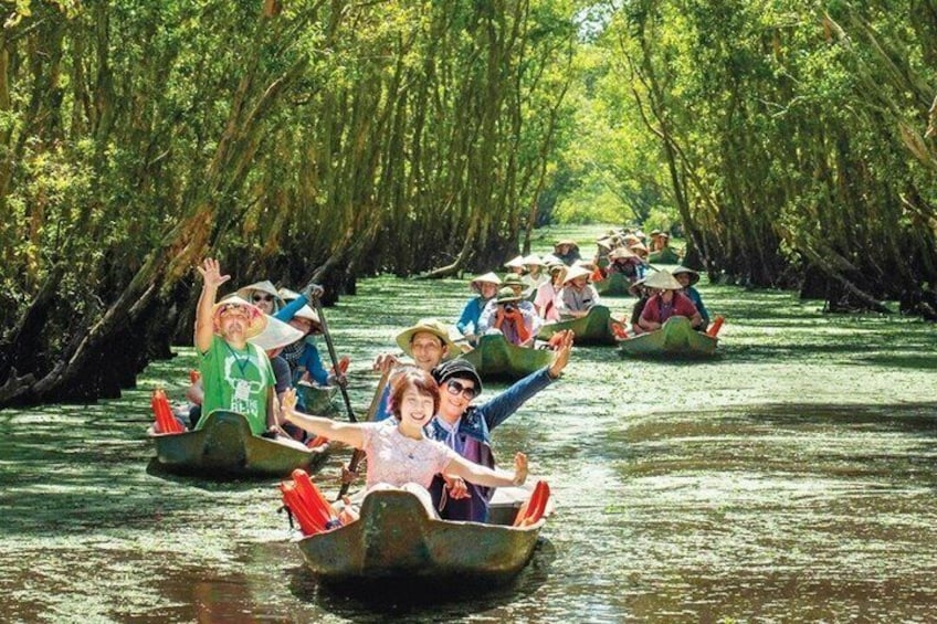 People in small boats on a river surrounded by dense trees. 5