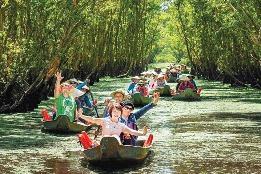 People in small boats on a river surrounded by dense trees. 5