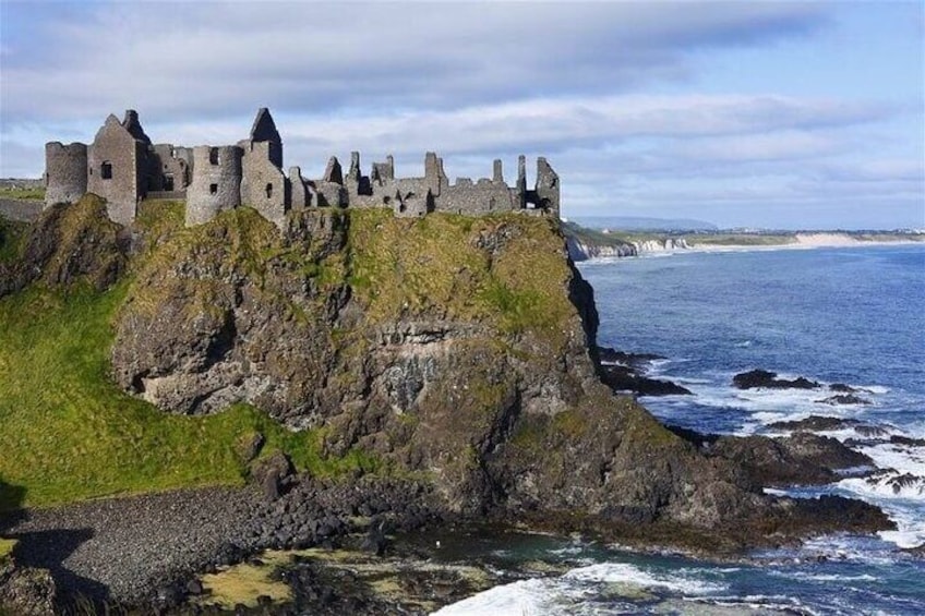 A coastal castle on a rocky cliff overlooking the sea. 5