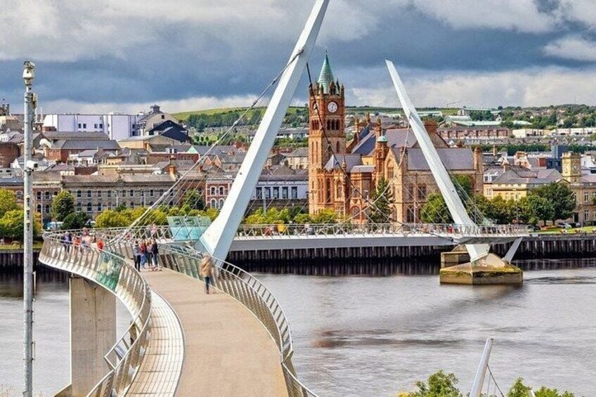 A modern bridge with a unique design, a historic church, and a river in the background. 2