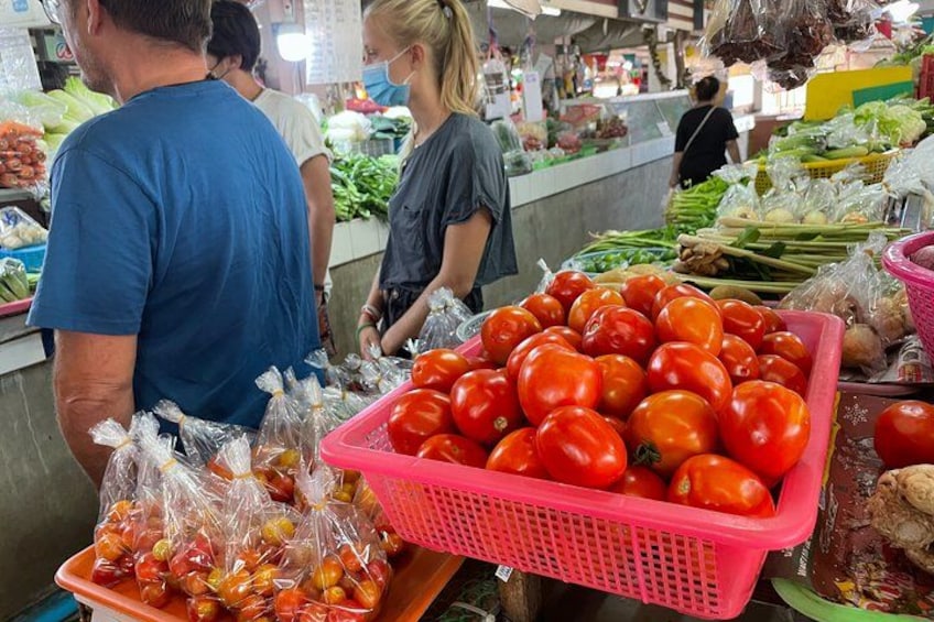 A market with fresh produce, including tomatoes and green onions. 2